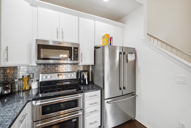 kitchen featuring white cabinets, appliances with stainless steel finishes, and decorative backsplash