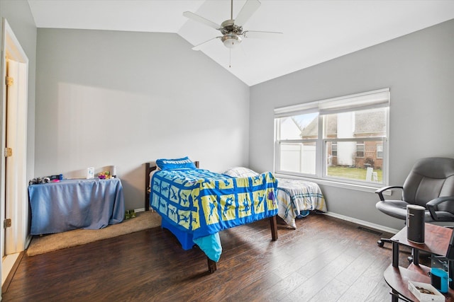 bedroom with baseboards, lofted ceiling, wood finished floors, and a ceiling fan