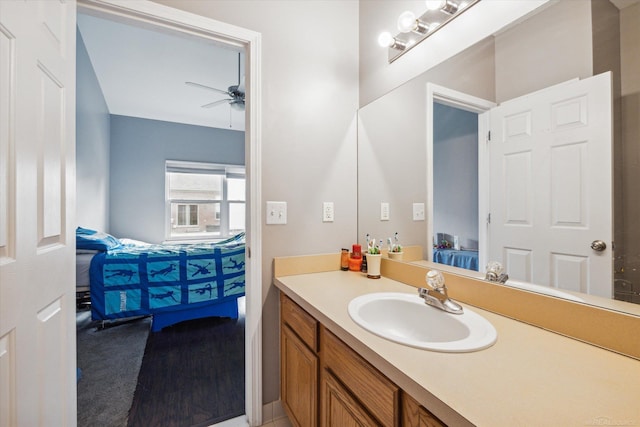 bathroom with connected bathroom, ceiling fan, and vanity