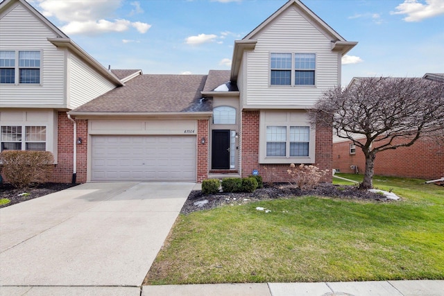 view of front facade with driveway, a front yard, an attached garage, brick siding, and a shingled roof