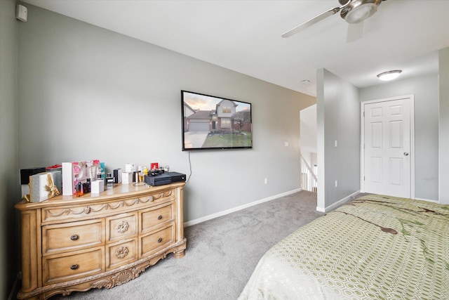 carpeted bedroom featuring baseboards and ceiling fan