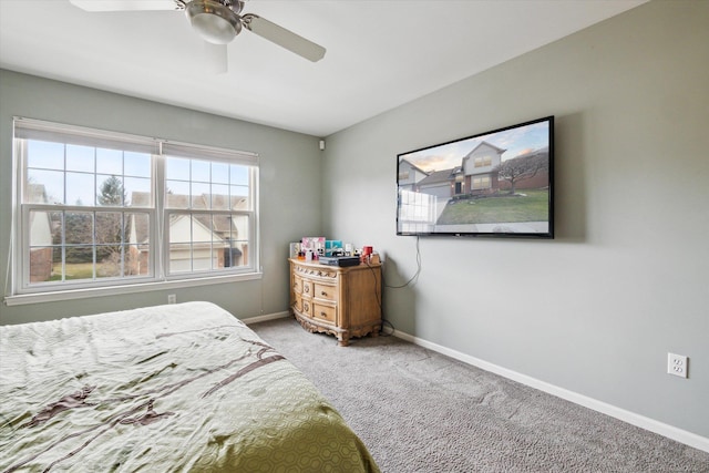 carpeted bedroom featuring a ceiling fan and baseboards