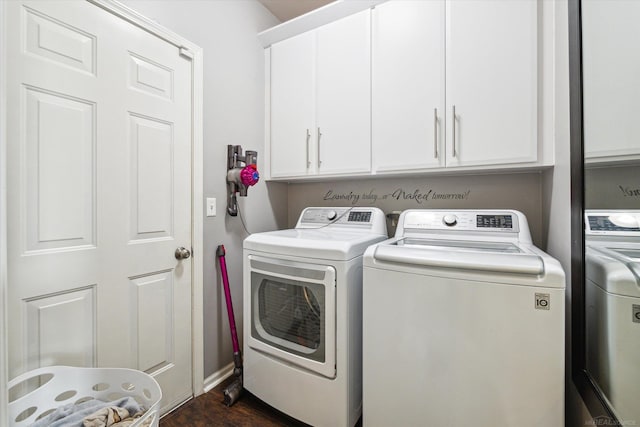 laundry area featuring washing machine and clothes dryer, cabinet space, and dark wood-style flooring