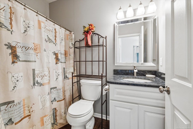 full bathroom with toilet, vanity, and curtained shower