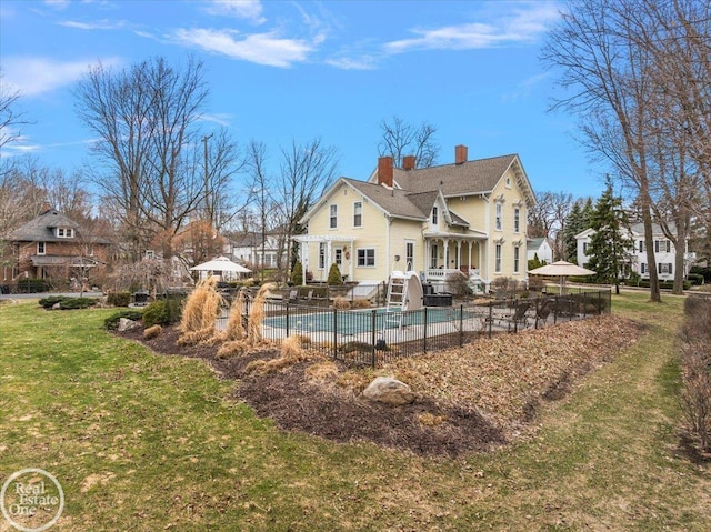 261 Church St, Romeo, MI 48065 - rear view of house featuring a chimney and a patio