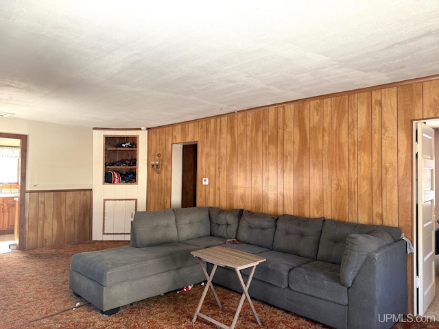 living room with wood walls and carpet