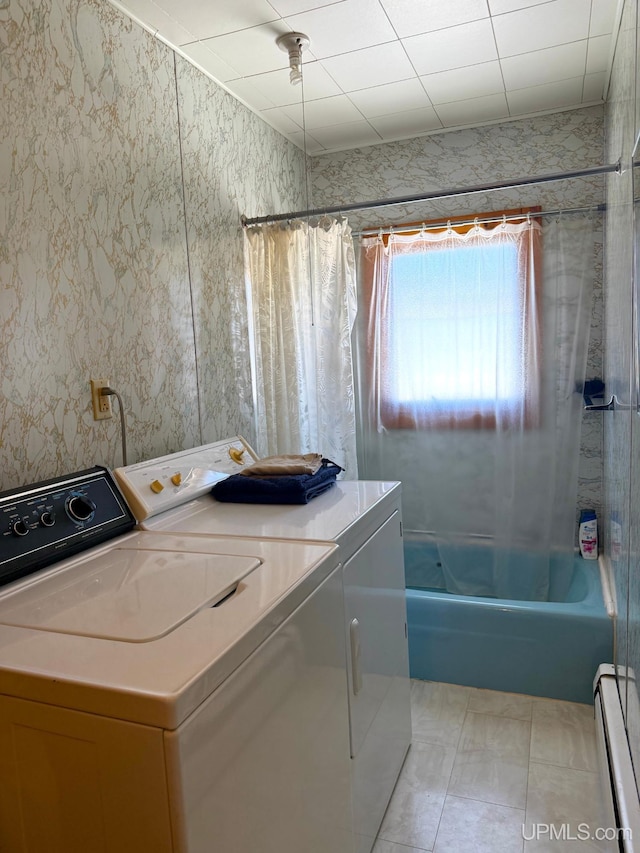 clothes washing area with a baseboard radiator and independent washer and dryer