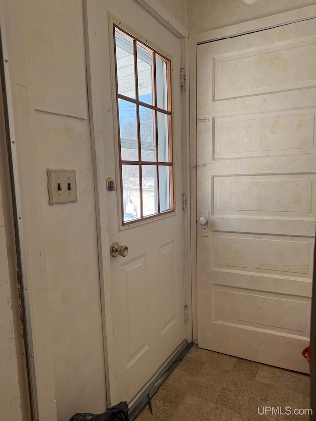 doorway to outside with tile patterned floors