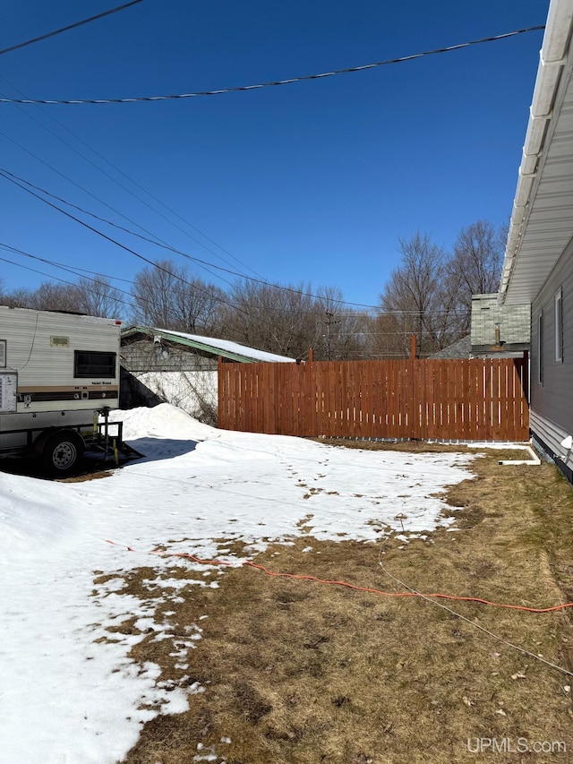 yard layered in snow with fence