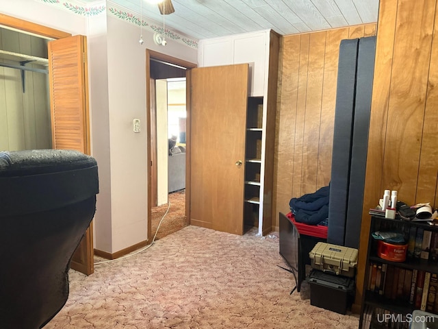 bedroom with wood walls and carpet