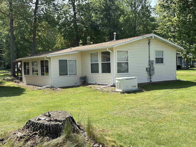 8686 Center Rd, Saint Helen, MI 48656 - rear view of house featuring a lawn and a fire pit