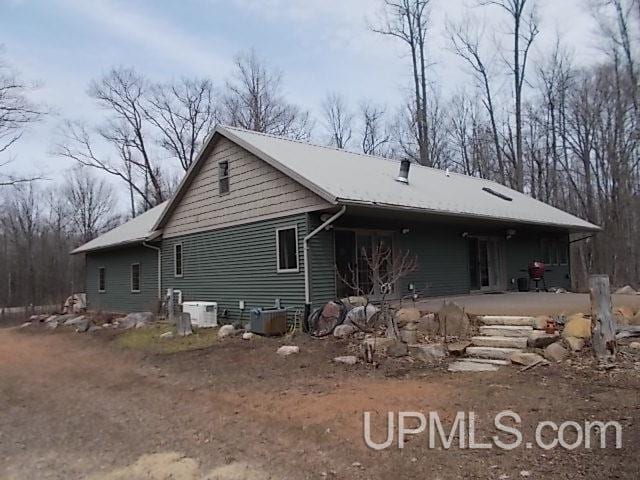 back of property featuring central AC unit
