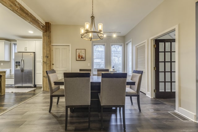dining room featuring baseboards, visible vents, dark wood-type flooring, and an inviting chandelier