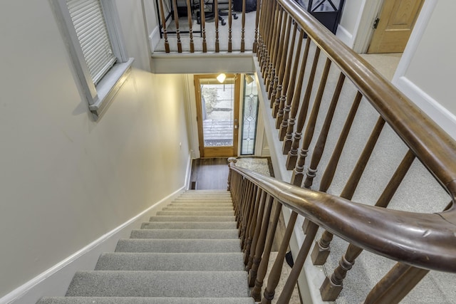 stairway featuring baseboards