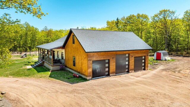 25195 Sved Rd, Hancock, MI 49930 - detached garage featuring dirt driveway and a shed