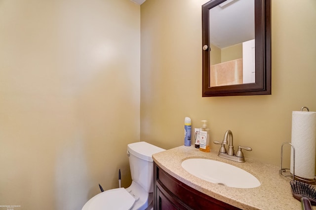 bathroom featuring toilet and vanity