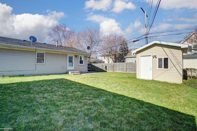view of yard featuring an outbuilding, fence, and entry steps
