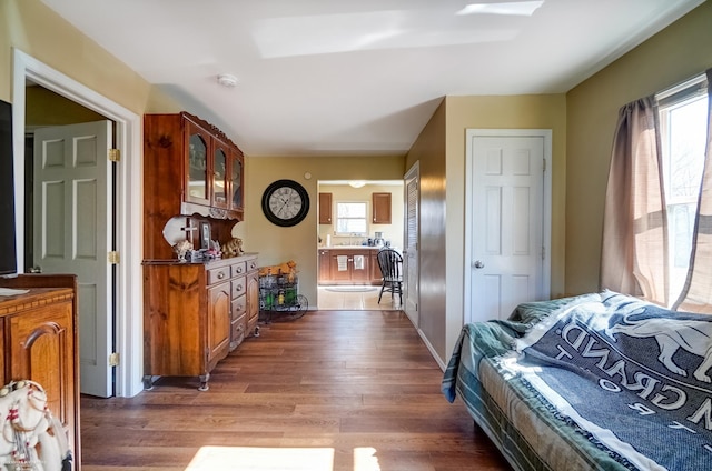 bedroom with baseboards and wood finished floors