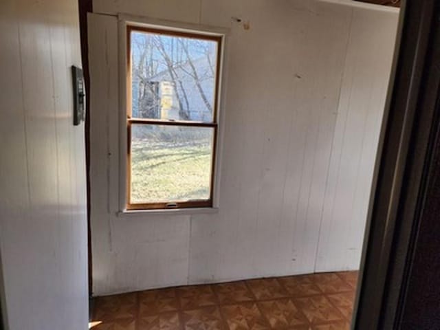 2488 Montana Ave, Saginaw, MI 48601 - empty room featuring plenty of natural light and wood walls