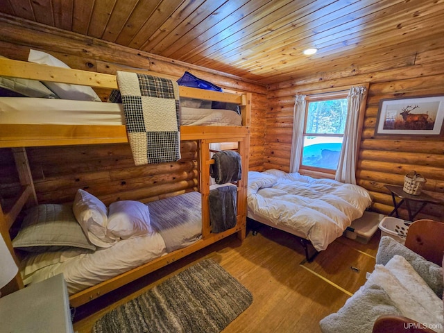 bedroom featuring wood ceiling, wood finished floors, and rustic walls
