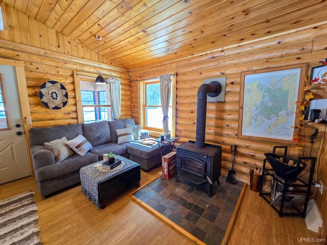 living room featuring a wood stove, rustic walls, wood ceiling, wood finished floors, and lofted ceiling