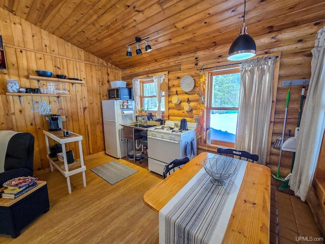 kitchen with log walls, white appliances, wood ceiling, wood finished floors, and vaulted ceiling