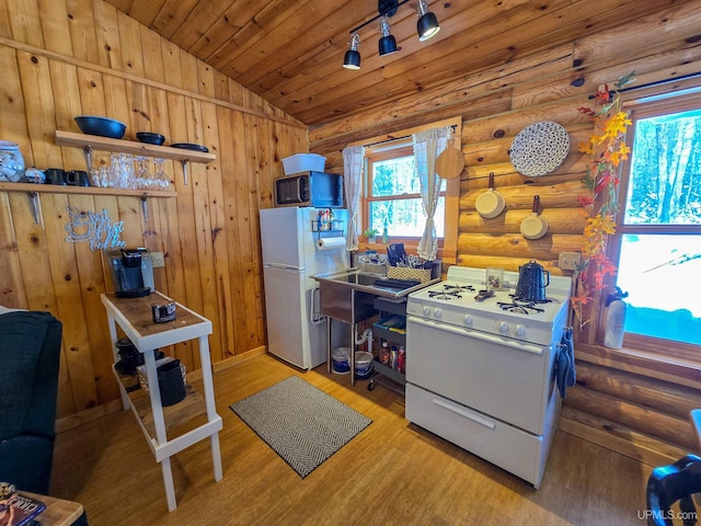 kitchen featuring white appliances, vaulted ceiling, rustic walls, wooden ceiling, and wood finished floors