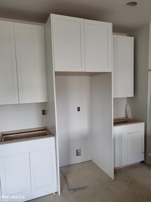 19279 Springbrook Dr Unit 175, Macomb Twp, MI 48044 - kitchen featuring white cabinetry, unfinished concrete flooring, and a sink
