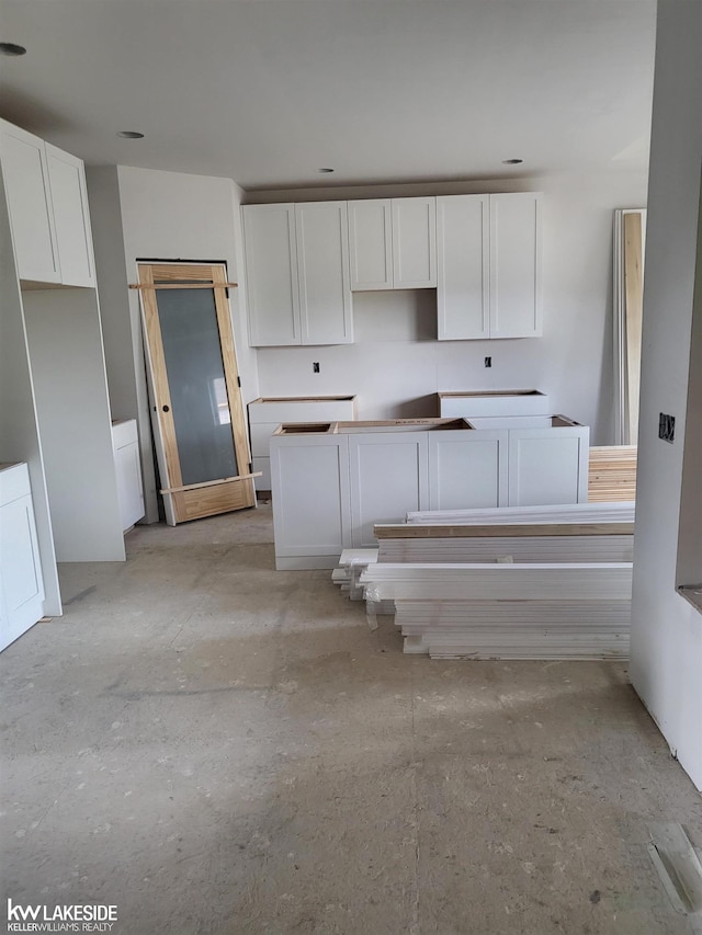 19279 Springbrook Dr Unit 175, Macomb Twp, MI 48044 - kitchen with white cabinetry and a kitchen island