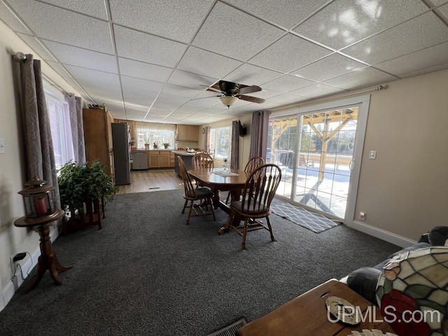 E3117 H44 Hwy, Trenary, MI 49891 - dining space featuring ceiling fan, light carpet, a drop ceiling, and baseboards