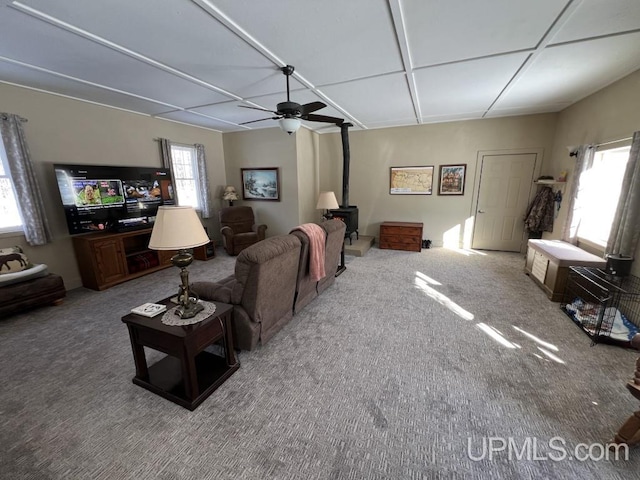 E3117 H44 Hwy, Trenary, MI 49891 - carpeted living room featuring a wood stove and ceiling fan