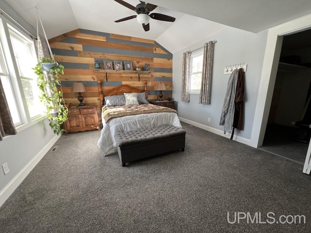 E3117 H44 Hwy, Trenary, MI 49891 - carpeted bedroom with vaulted ceiling, wood walls, baseboards, and ceiling fan