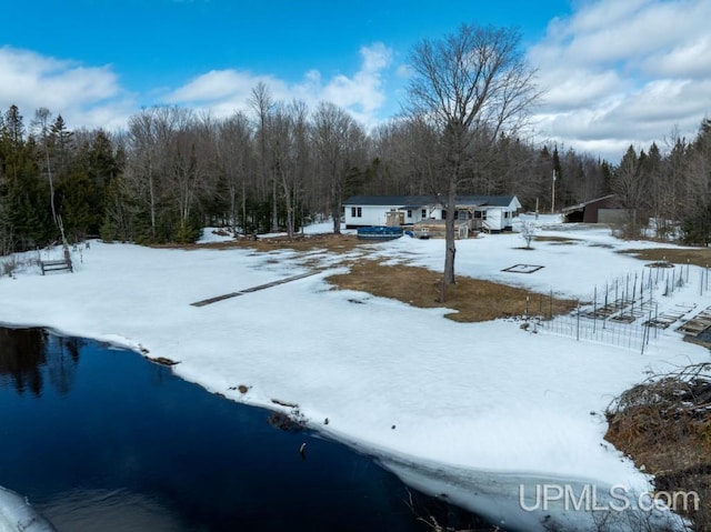 E3117 H44 Hwy, Trenary, MI 49891 - yard layered in snow with a forest view