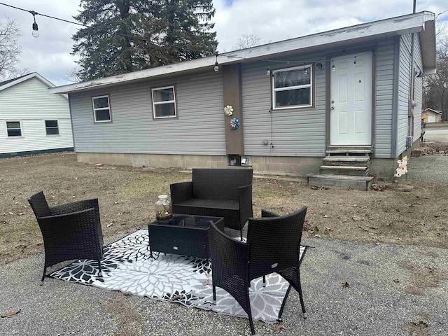 rear view of house featuring entry steps and a patio
