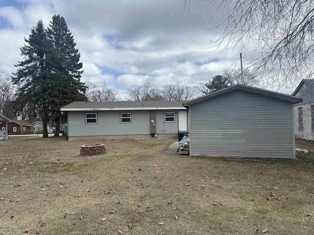 back of house with a fire pit