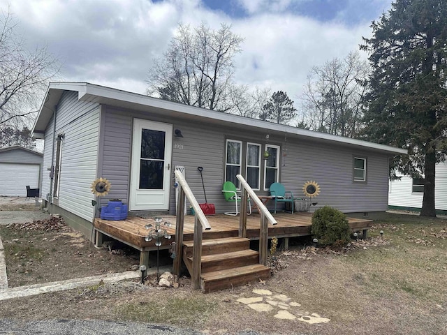 view of front of property with a garage, crawl space, an outdoor structure, and a wooden deck