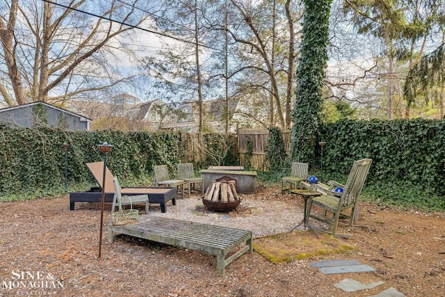 view of yard featuring an outdoor fire pit and a fenced backyard