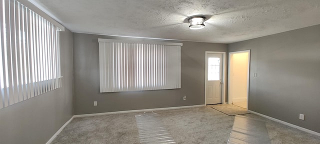 1346 Carlisle St, Saginaw, MI 48601 - carpeted spare room featuring baseboards and a textured ceiling