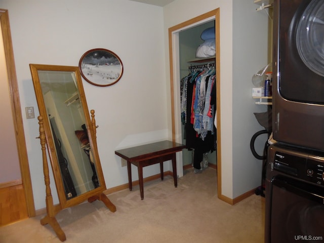 49436 S Superior Rd, Houghton, MI 49931 - interior space with stacked washing maching and dryer, light colored carpet, and baseboards