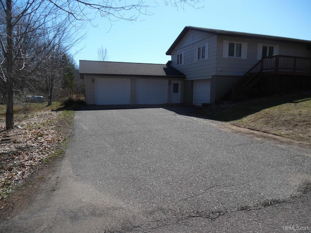49436 S Superior Rd, Houghton, MI 49931 - view of front of home with aphalt driveway, stairs, and a garage