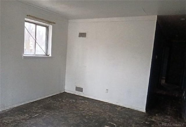 empty room featuring visible vents and unfinished concrete floors