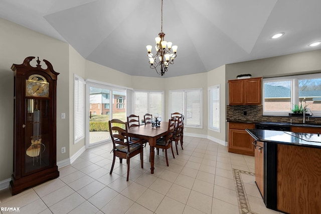 55763 Omni Dr, Shelby, MI 48315 - dining area featuring a chandelier, light tile patterned floors, baseboards, and lofted ceiling