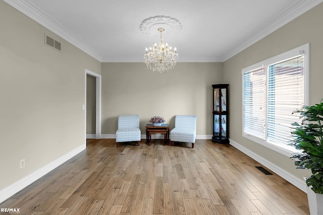 55763 Omni Dr, Shelby, MI 48315 - living area featuring visible vents, baseboards, an inviting chandelier, crown molding, and wood finished floors