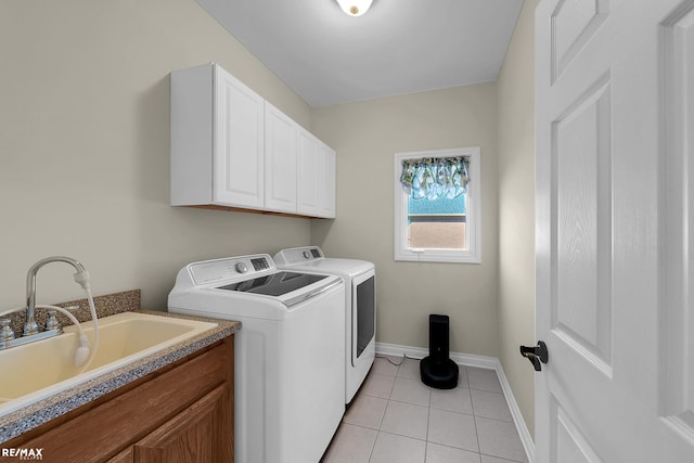 55763 Omni Dr, Shelby, MI 48315 - clothes washing area with light tile patterned floors, baseboards, a sink, cabinet space, and washer and clothes dryer