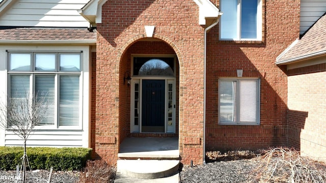 55763 Omni Dr, Shelby, MI 48315 - property entrance featuring a shingled roof and brick siding