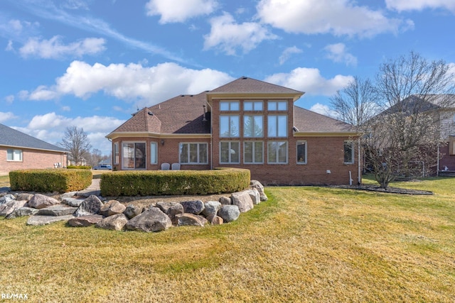 55763 Omni Dr, Shelby, MI 48315 - back of house with a yard, a shingled roof, and brick siding