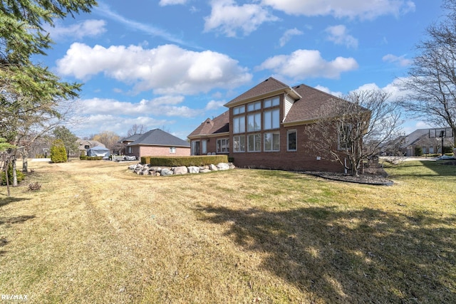 55763 Omni Dr, Shelby, MI 48315 - rear view of house with a yard, brick siding, and a shingled roof