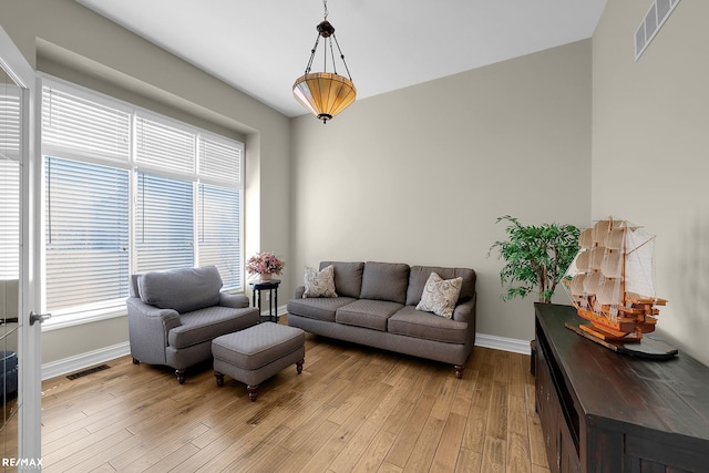 55763 Omni Dr, Shelby, MI 48315 - living area with visible vents, baseboards, and light wood-style floors