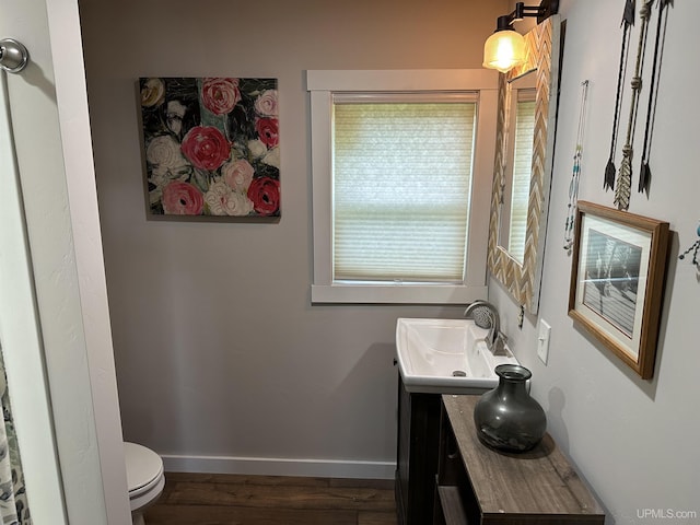 6234 State St, Garden, MI 49835 - bathroom featuring vanity, toilet, wood finished floors, and baseboards