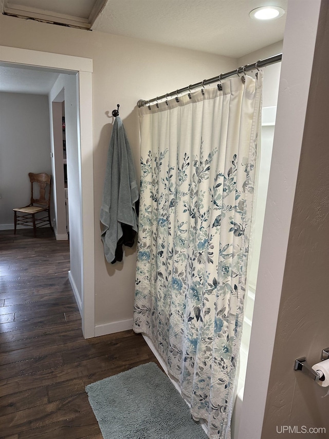 6234 State St, Garden, MI 49835 - bathroom with wood finished floors, baseboards, and shower / bath combination with curtain
